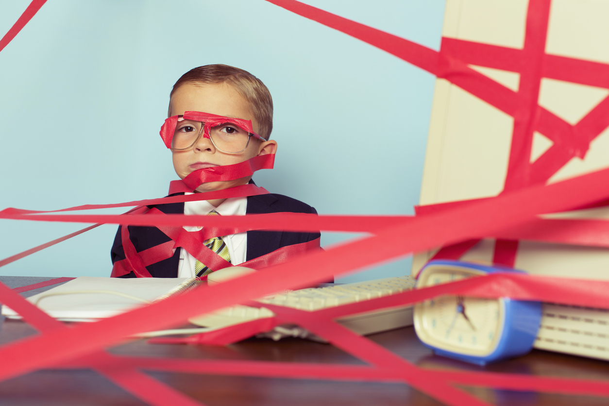 Boy in Suit Tangled in Red Tape